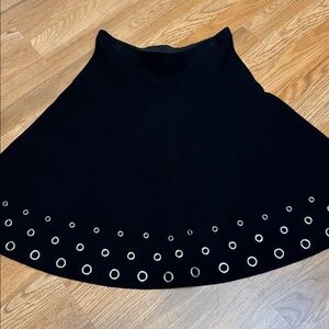 Sioni elegant black knit skirt with heavy silver-tone eyelet details. Size L.